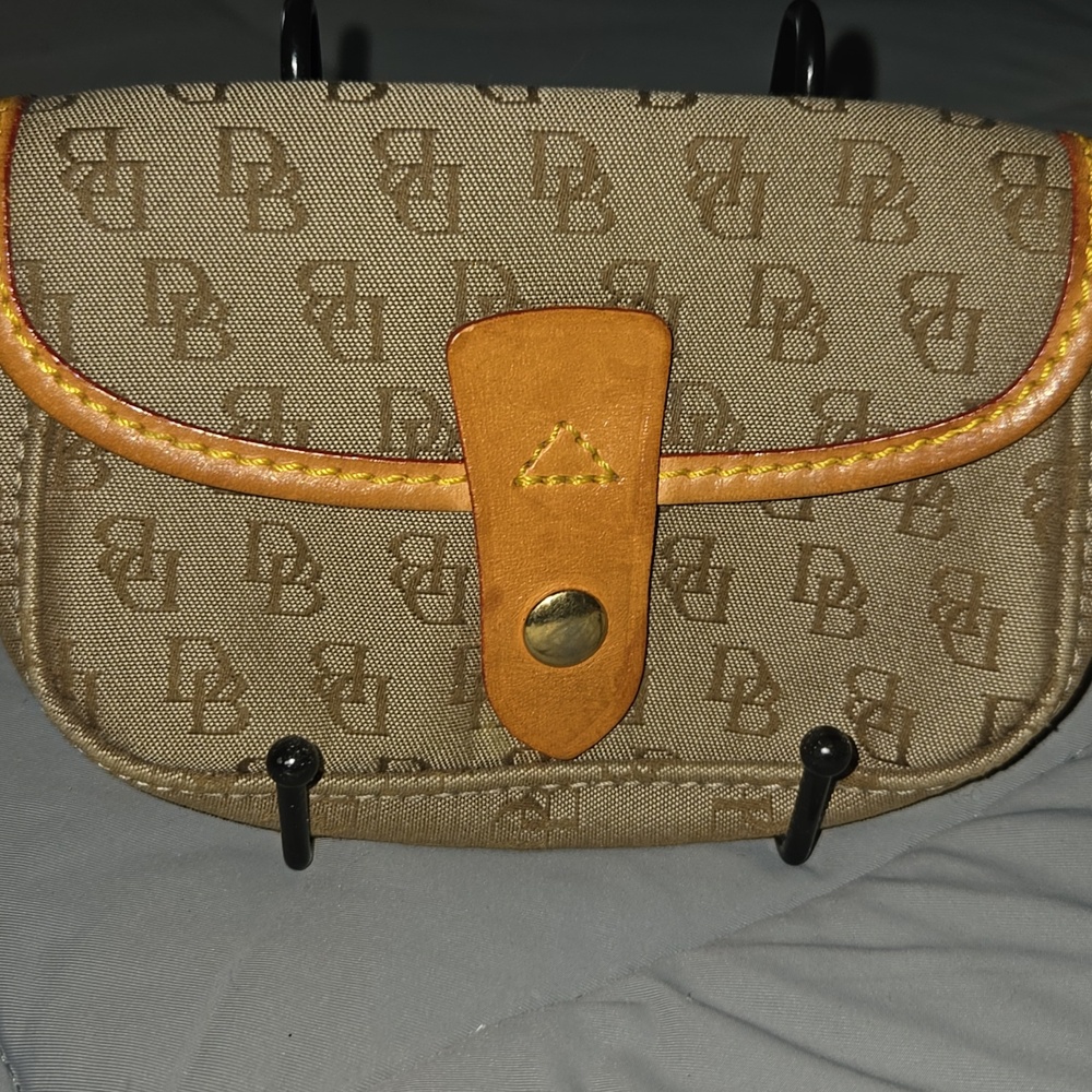 Dooney & Bourke Vintage Signature monogram flap wristlet featuring brown leather